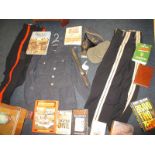 A quantity of military uniforms, weaponry and associated books