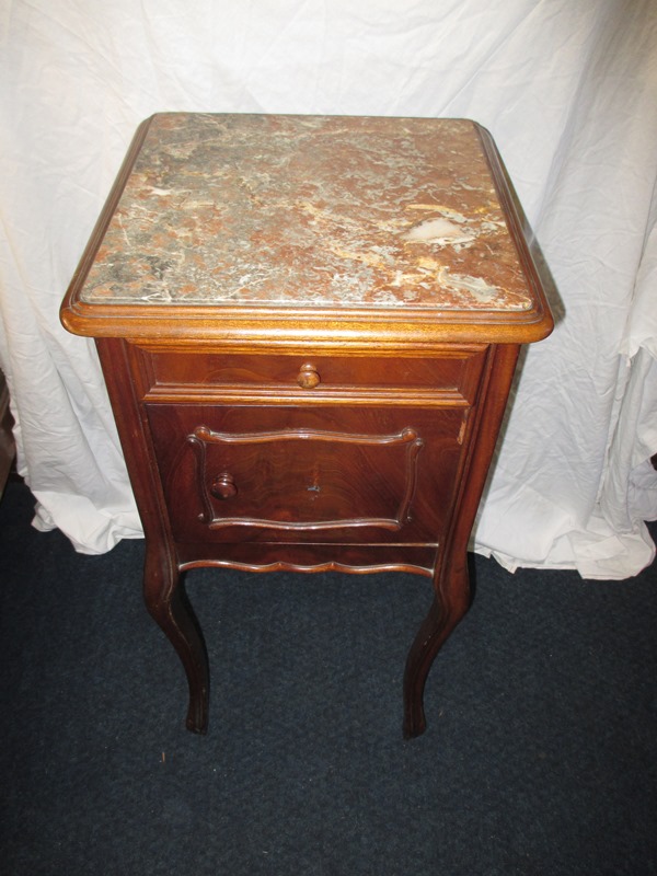A mahogany marble topped bed side cabinet