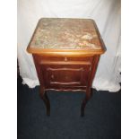 A mahogany marble topped bed side cabinet