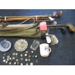 A quantity of golf collectables to include hickory shafted clubs and ball markers