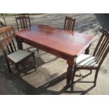 An antique dining table with 4 chairs