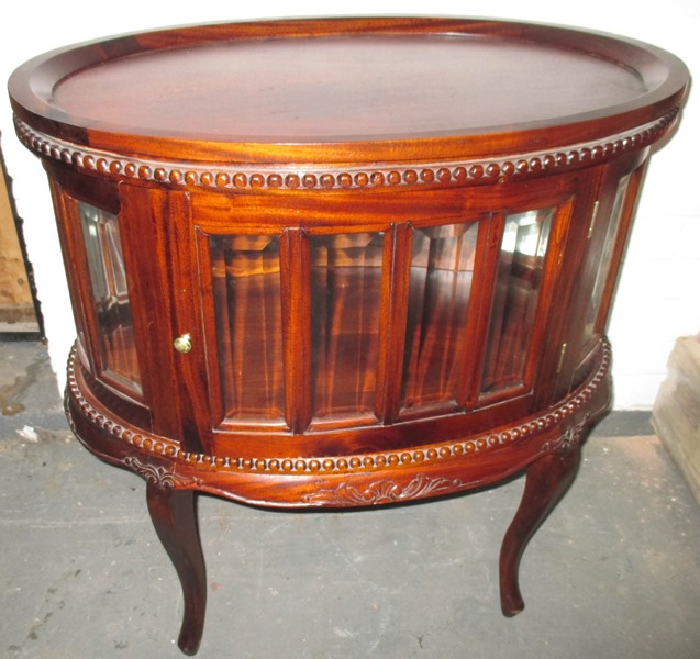 An early 20th century glazed drinks cabinet with removable tray top