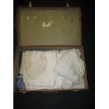 A vintage leather suit case with contents of 19thC and later lace clothing