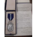 A Sterling silver masonic jewel in original box with letter