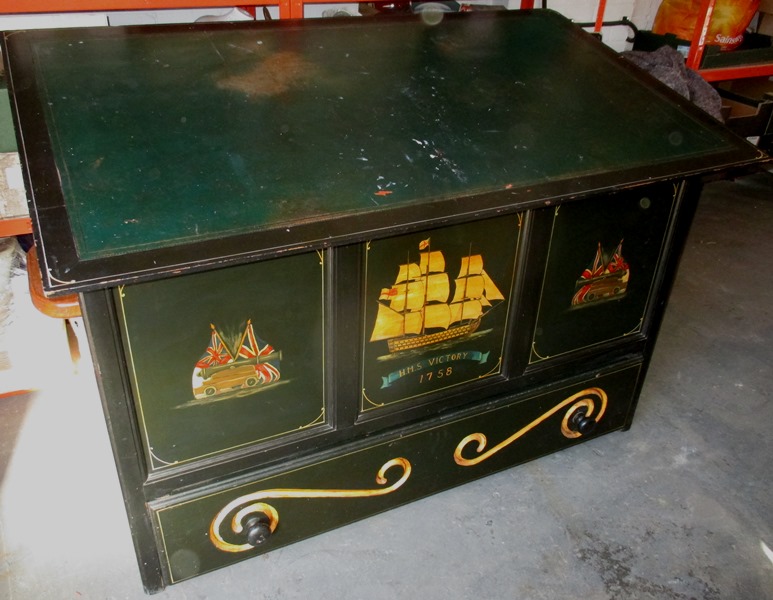 A large drawing chest, the top inlaid with a leather writing surface above a storage box and base