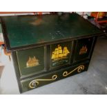 A large drawing chest, the top inlaid with a leather writing surface above a storage box and base