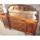 A late 19th century sideboard with central drawer unit and mirrored top rail
