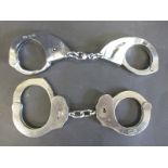 Two pairs of vintage handcuffs by Hiatt and Alcyon