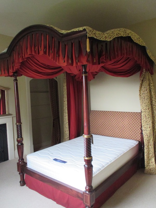A four poster bed with all associated hangings