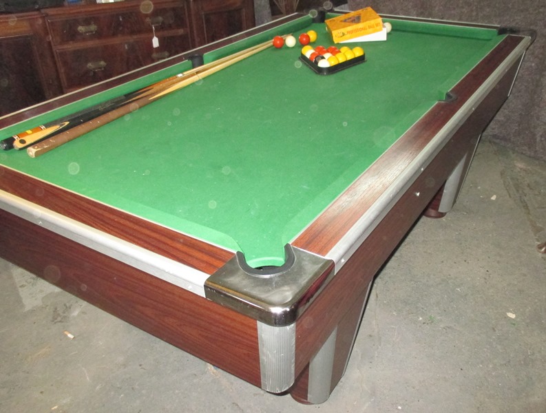A full size slate bed pool table with accessories