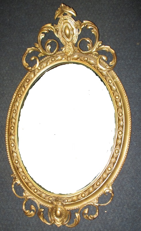 An antique carved wood framed wall mirror
