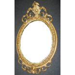 An antique carved wood framed wall mirror