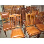 A harlequin set of 14 oak dining chairs with brown leather covers