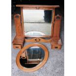 An oak arts and craft mirror and 1 other