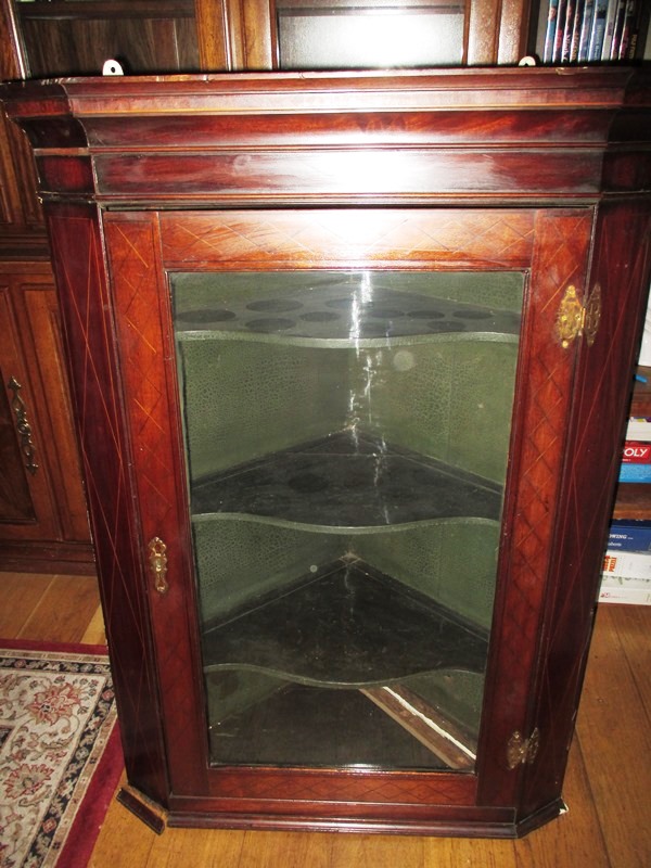 A Georgian mahogany wall mounted Corner cupboard with geometric inlaid decoration