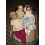 An early 20th century bisque head doll and two others