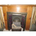 A pine fireplace with tile inset surround, marble hearth and basket