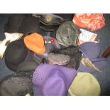 A quantity of vintage hats to include military and art deco examples