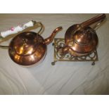 Two 19th century copper kettles and a brass trivet