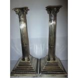 A pair of Edwardian sterling silver Corinthian column candlesticks, by Walker & Hall.