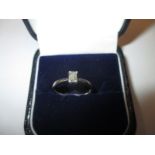 An 18ct white gold ring set with a single square cut diamond