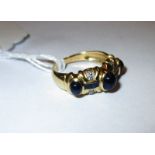 An Egyptian 18ct gold ring set with diamonds and sapphires