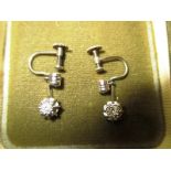 A pair of 9 ct gold screw on earrings each mounted with a solitaire diamond