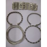 Five sterling silver bracelets to include two torques