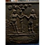 A cast iron fire back with Adam & Eve