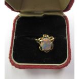 A 14 ct yellow gold ring set with a central fire-opal