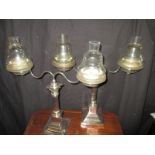 A pair of twin branch silver plated Cricklite candlesticks with original glass fitments and spares