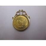 A 1/10 Krugerrand in a gold coin mount