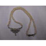 A 14 ct white gold diamond and natural pearl necklace