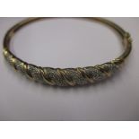 A 9ct gold and diamond bangle