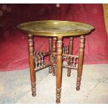 An Indian brass top folding table