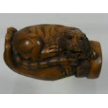 An Oriental Carved Wood Netsuke Of Tiger