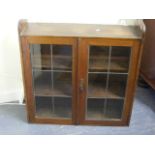 A Oak Wall Cabinet With Lead Glazed Doors