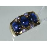 An 18ct Gold Ring Set With Diamonds & Cabochon Sapphires