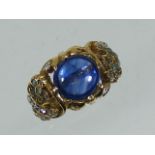 An 18ct Gold Ring With Diamonds & Cabochon Sapphire