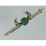 An 18ct Gold Arts & Crafts Enamelled Brooch Bearing A Carved Emerald