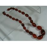 A Set Of Bakelite Amber Beads