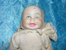 A Three Faced Porcelain Headed Doll