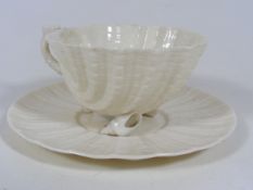 A Belleek Shell Footed Cup With Saucer