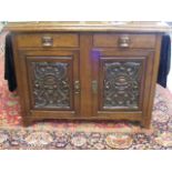 A Heavily Carved Oak Sideboard With African Influe