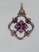 A Small Pendant With Pink Stones