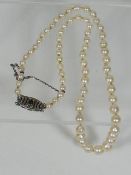 A Set Of Ladies Pearls With Silver Clasp Set With