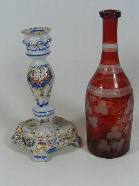 A French Faience Candlestick Twinned With An Antiq