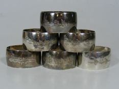 A Set Of Six White Metal Napkin Rings