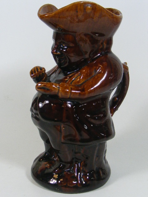 A Rockingham Treacle Glaze Snuff Taker Toby Jug