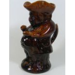 A Rockingham Treacle Glaze Snuff Taker Toby Jug